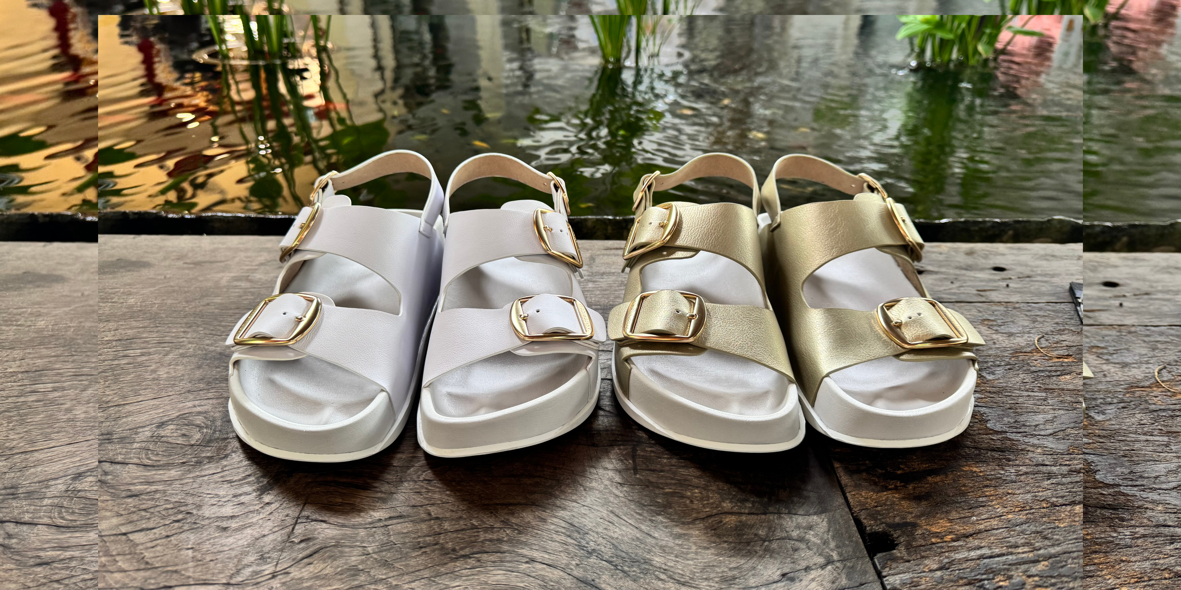 Gold and white orthotic sandals next to pond