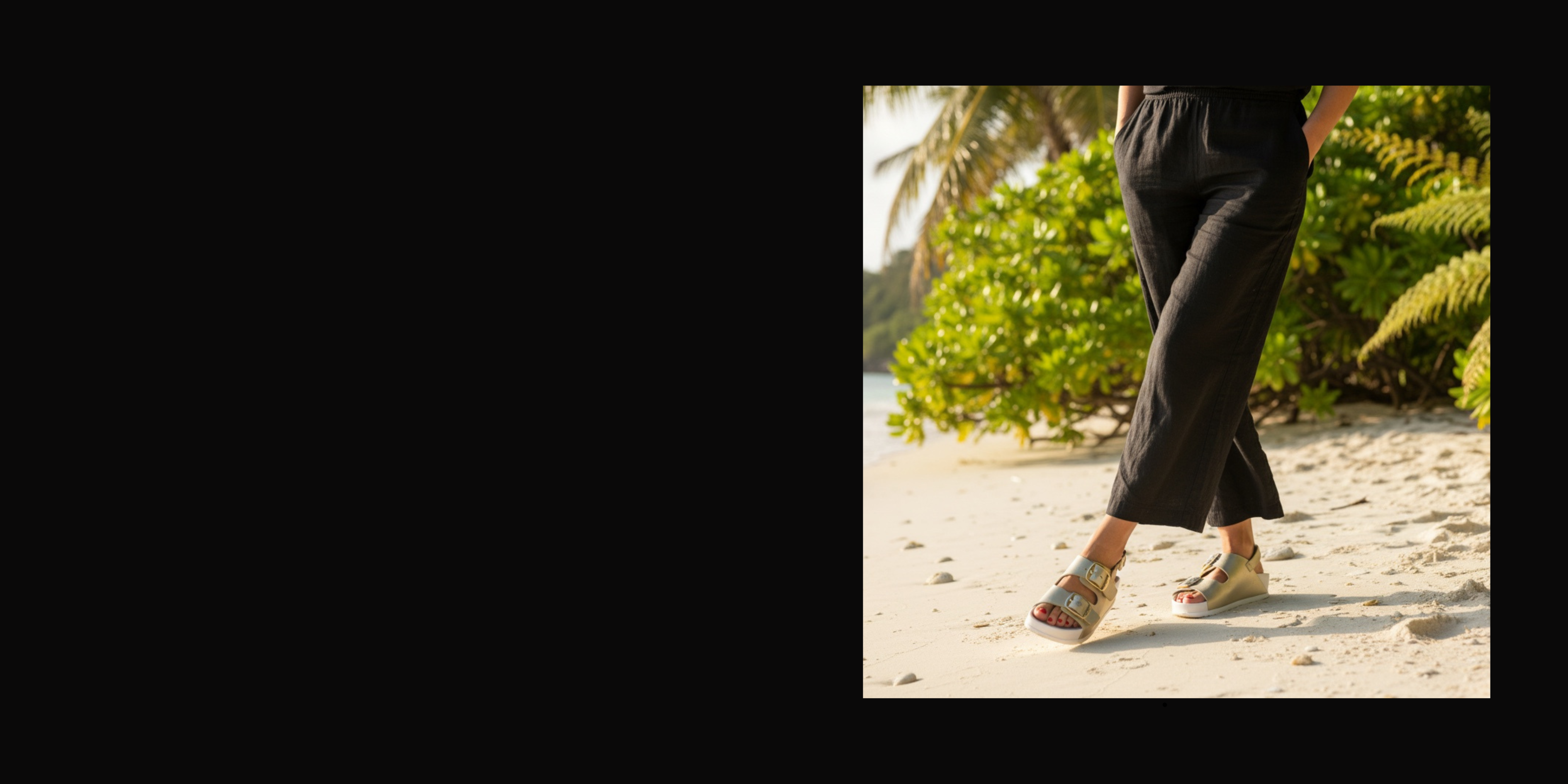 Person walking on a sandy path with greenery in the background